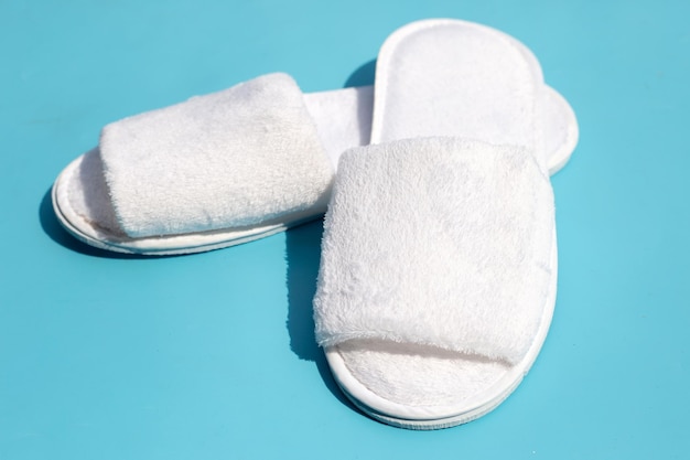 Hotel slippers on blue background