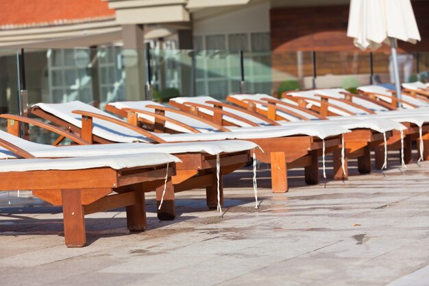 Hotel Wooden Poolside Chairs. Horizontal shot