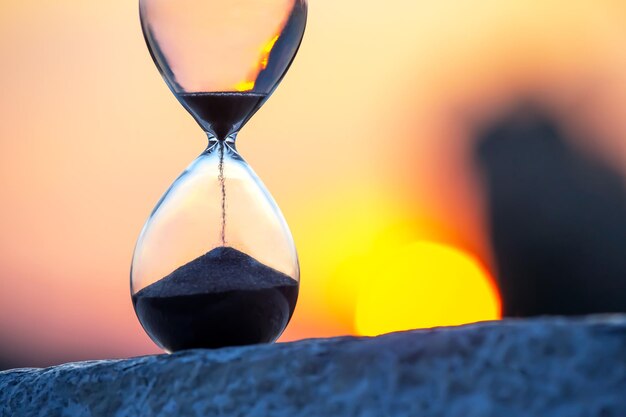 Hourglass on the background of a sunset The value of time in life An eternity