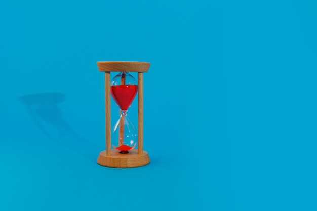 Hourglass on blue on blue background