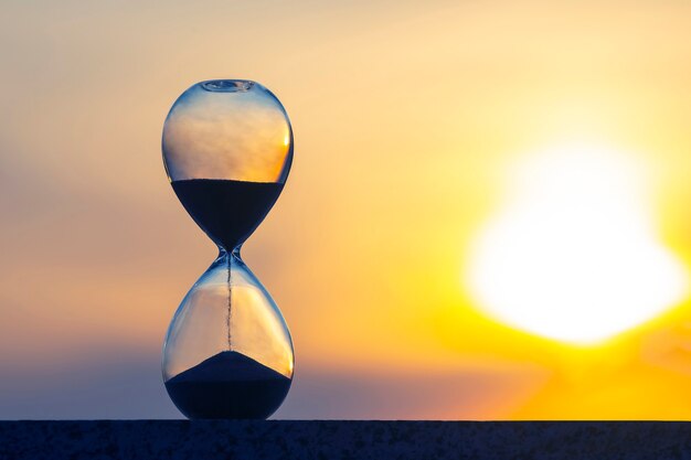 Hourglass counts the length of time against evening sun