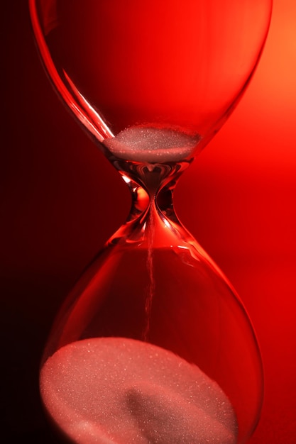 Hourglass on dark red background