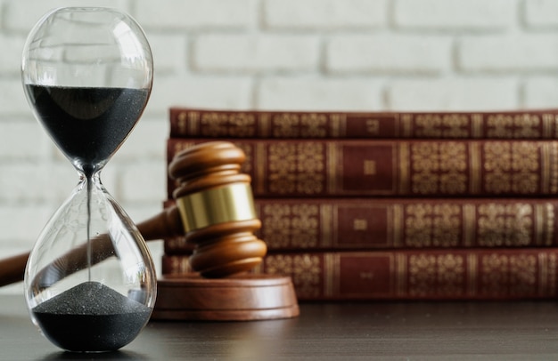 Hourglass and judge gavel on table