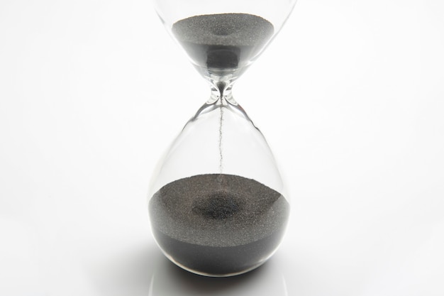 Hourglass on a light . Time is money. Business solutions in time.