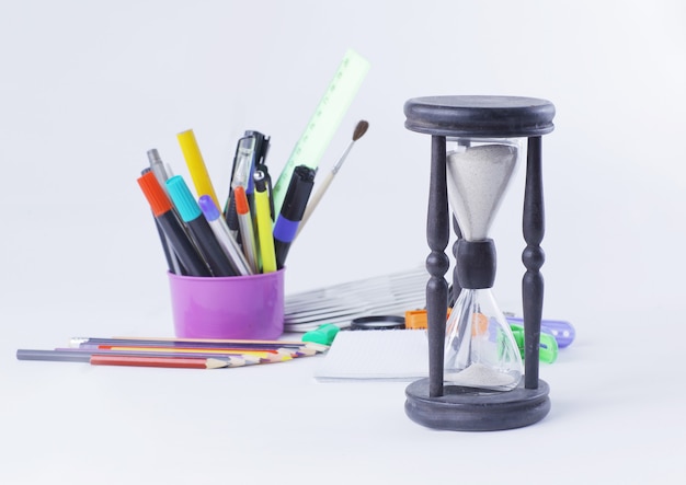 Hourglass and office supplies