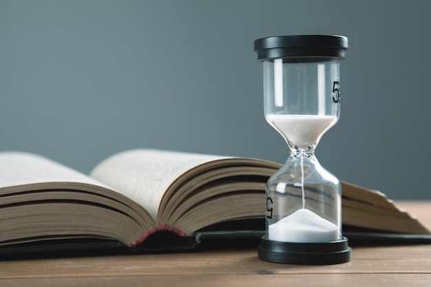 Hourglass with books on the table