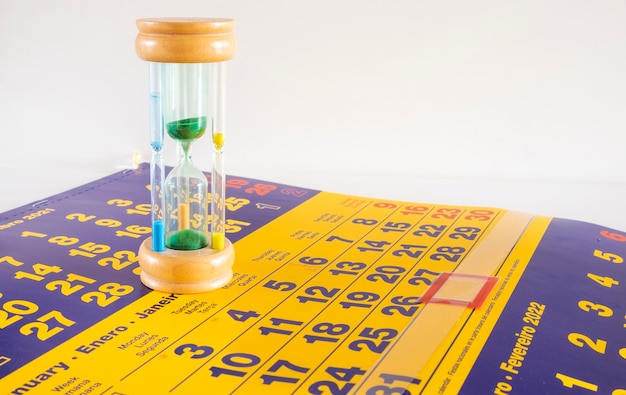 An hourglass with four glass cylinders and different colored sand