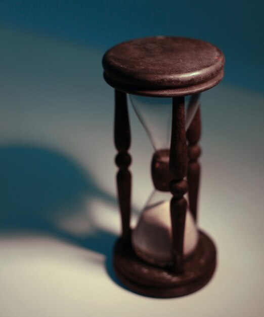 Hourglass on a yellow background.The concept of time.