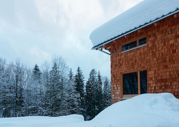 House architecture and snowy winter landscape in Bad Goisern village near Hallstatt in Upper Austria. Townhouse real estate and residential building.