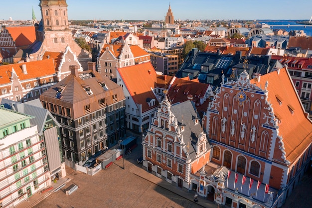 House of the Blackheads and Saint Peters church in Riga in a beautiful summer evening in Latvia. Aerial view from above.