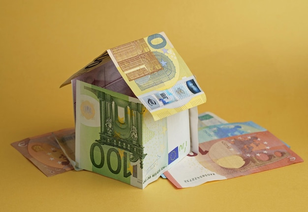 House built from banknotes House made from euro banknotes concept for real estate prices mortgages or home financing