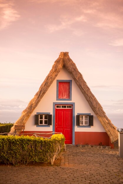 House by building against sky during sunset