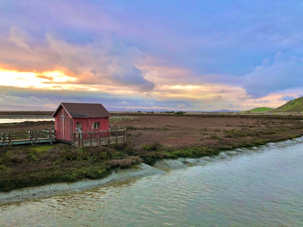 House by building against sky during sunset