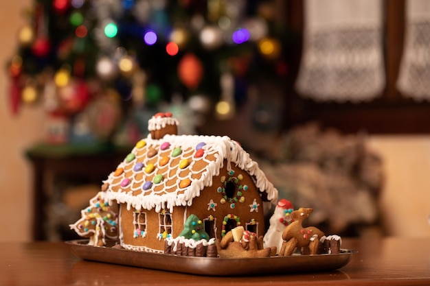 House cake on table decorated with smarties