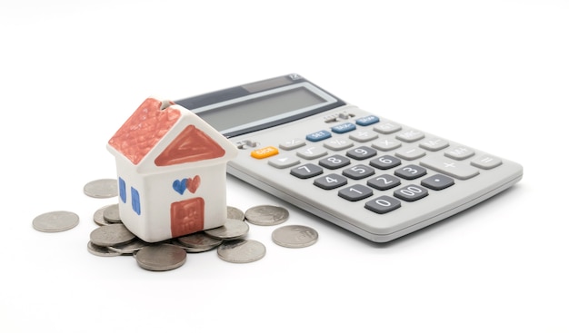 House and calculator on white background