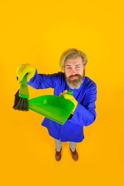 House cleaning broom bearded man with little broom cleaning and disinfection professional cleaning