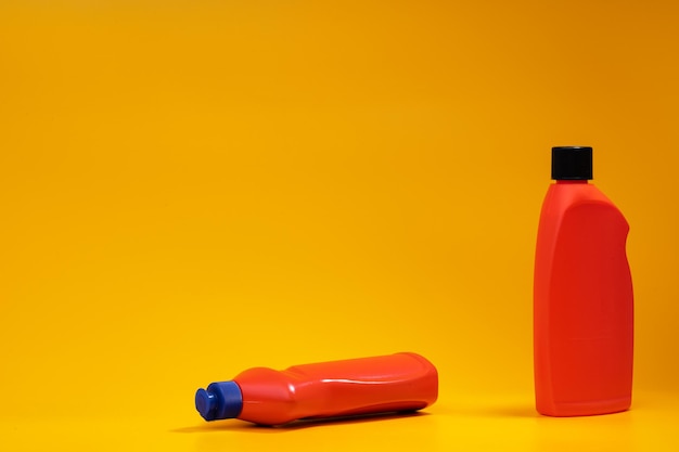 House cleaning detergent bottles on a yellow background