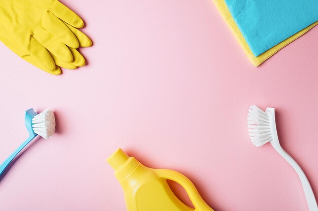 House cleaning product on pink background copy space