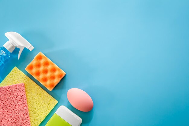 Photo house cleaning products on blue background flat lay