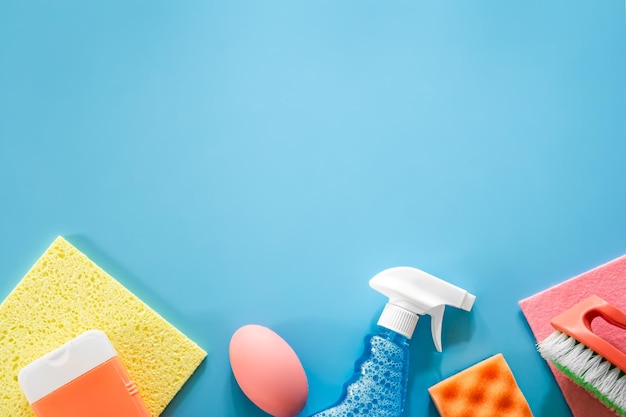 House cleaning products on blue background flat lay