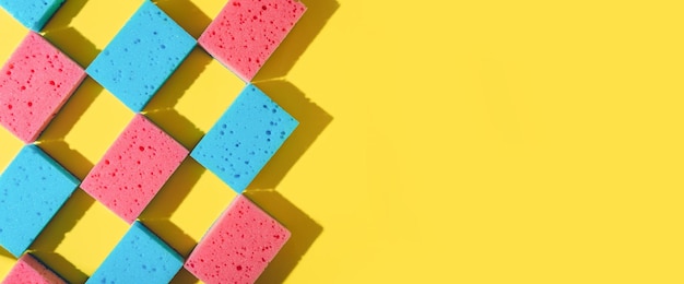 House cleaning sponges on yellow background