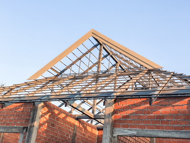 House construction site use red bricks as a wall. with steel roof frame concrete pillar