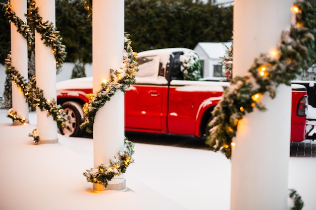 House decorated for Christmas with red car