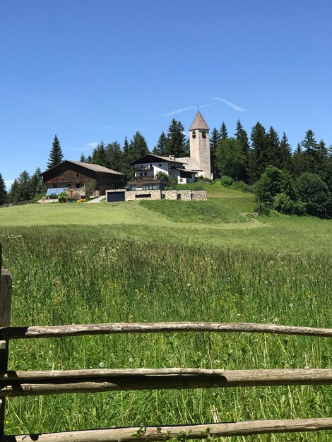 House on field against clear sky