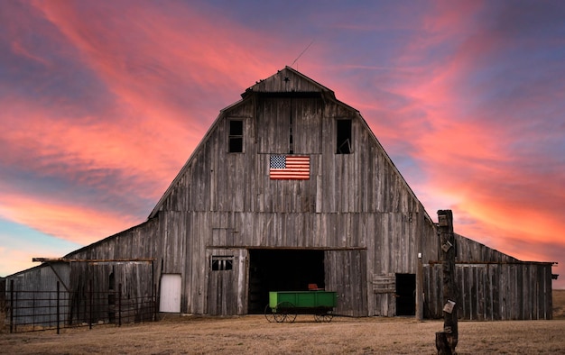 House on field against sky during sunset