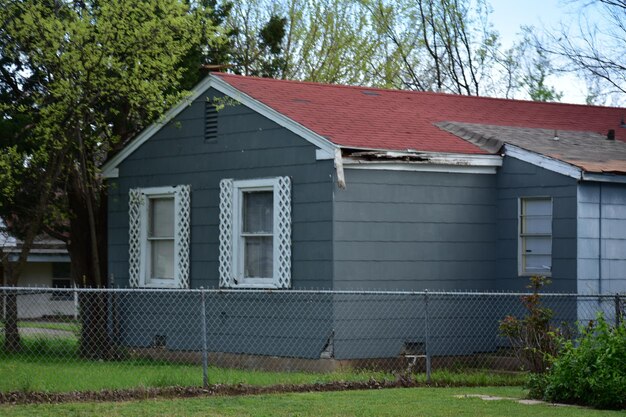 House on field against trees