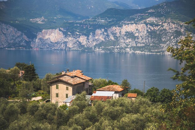 A house on a hill overlooking a lake with mountains in the background.