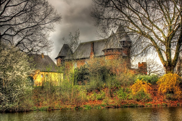 Photo a house on a hill with a house on the side and a tree in the background