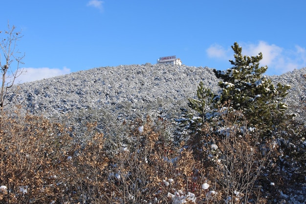 A house on a hill with snow on the ground