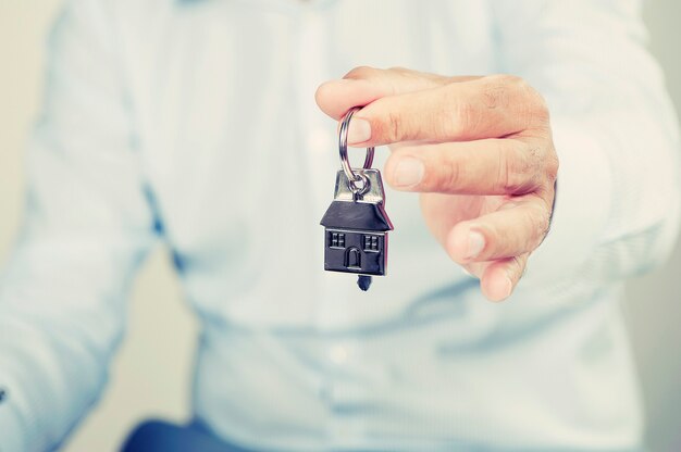 House key in businessman hand with clipping path