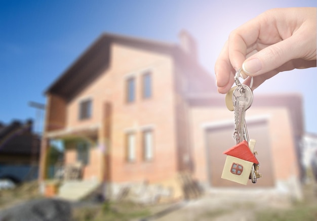 Photo house keys on house construction background