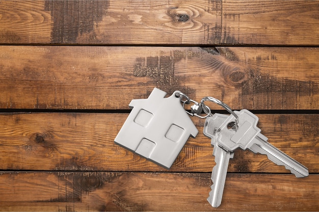 Photo house keys   on wooden floor  background