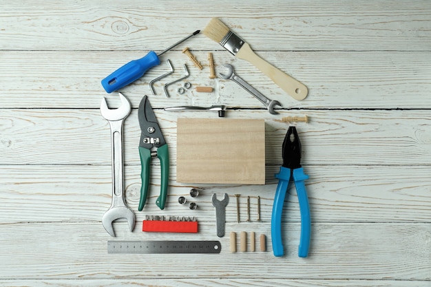 Photo house made of working tools on white wooden