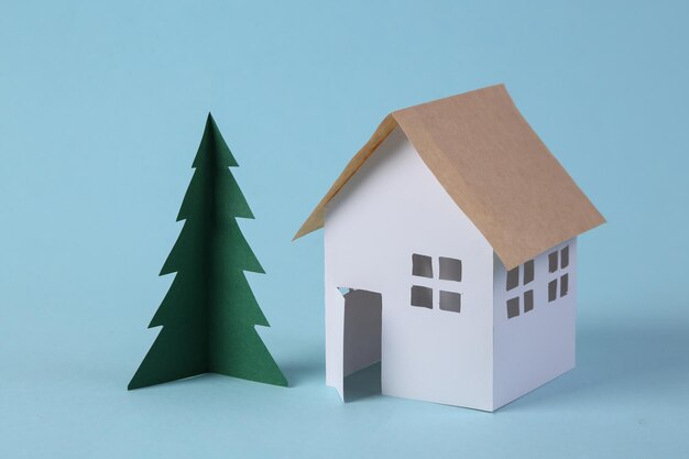 House model and a Christmas tree on a blue background