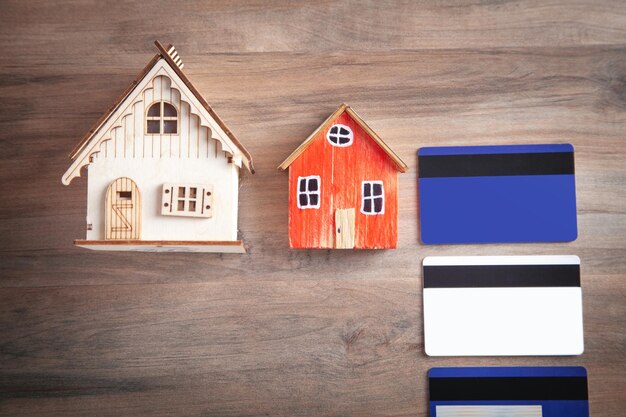 Photo house model and credit card on the wooden table