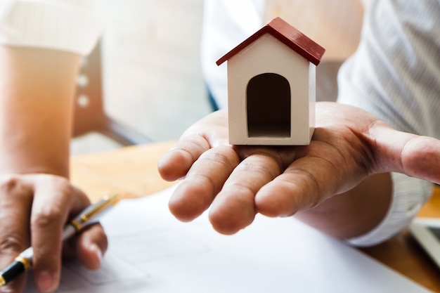 House model dummy on hand of Architect or engineer. architectural concept