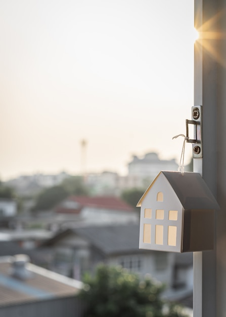 House model hang on window of home.