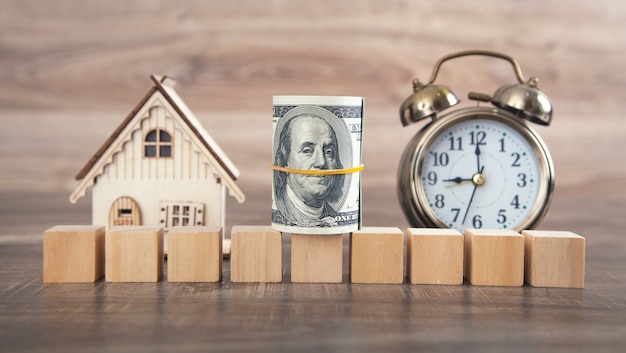 Photo house model, money and empty wooden cubes.