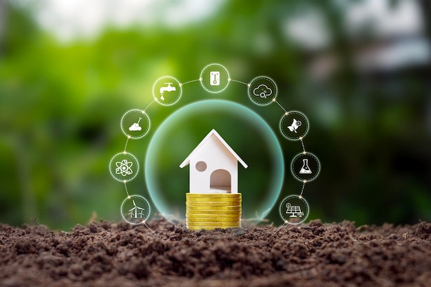 Фото Модель дома на суше с иконой чистой энергии концепция экологически чистого дома и энергосберегающего и экологически чистого дома