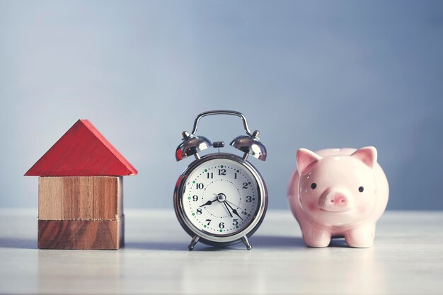 House model with clock and piggy bank