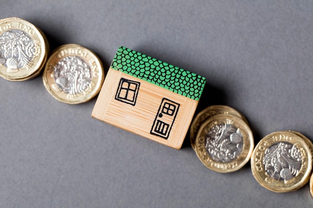 House model with coins Home finance concept