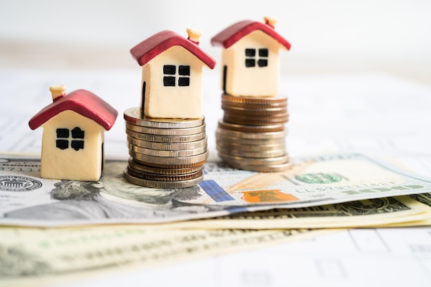 house model with stack of coin money home loan saving plan installment payment finance and banking concept