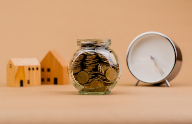 house money and time Saving money to build a house buy a house savings in a glass bottle Financial loans home loans time to build a house Wealthy life with money house and time