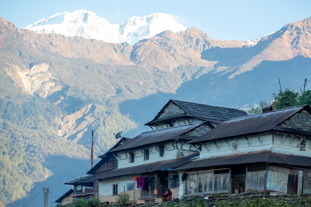 A house in the mountains with a mountain in the background