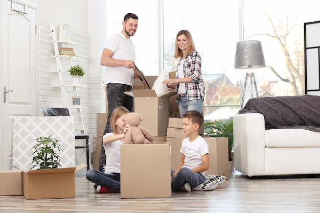 House move concept Family unpacking cardboard boxes in new home