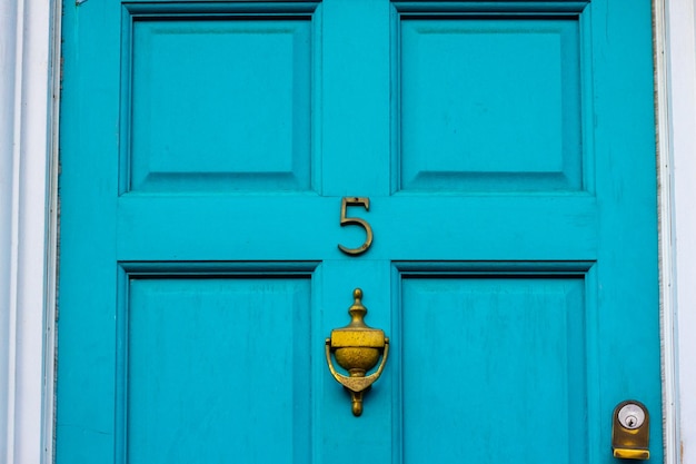 House number 5 on a blue wooden front door in london